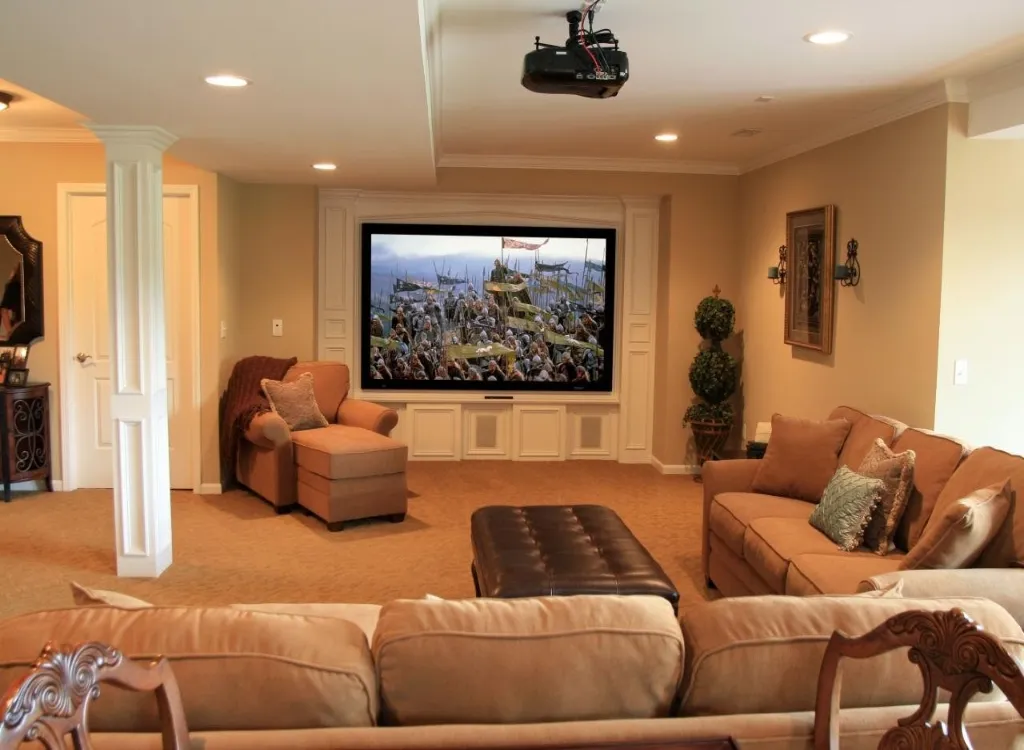 A finished basement with a television and couches.